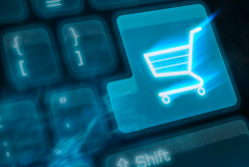 Symbol of a shopping trolly on a computer key representing online shopping and ecommerce