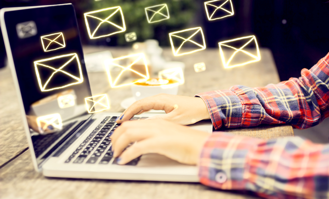 Typing on laptop - The benefits of sponsoring an email newsletter
